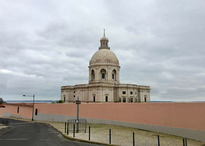 Historic church against cloudy sky