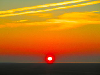 Scenic view of sea against orange sky