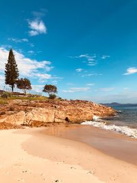 Scenic view of beach against blue sky