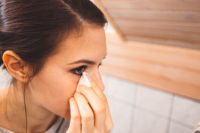 Close-up of young woman looking away