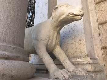 Low angle view of statue against old building