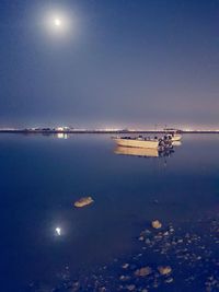 Scenic view of sea against sky at night