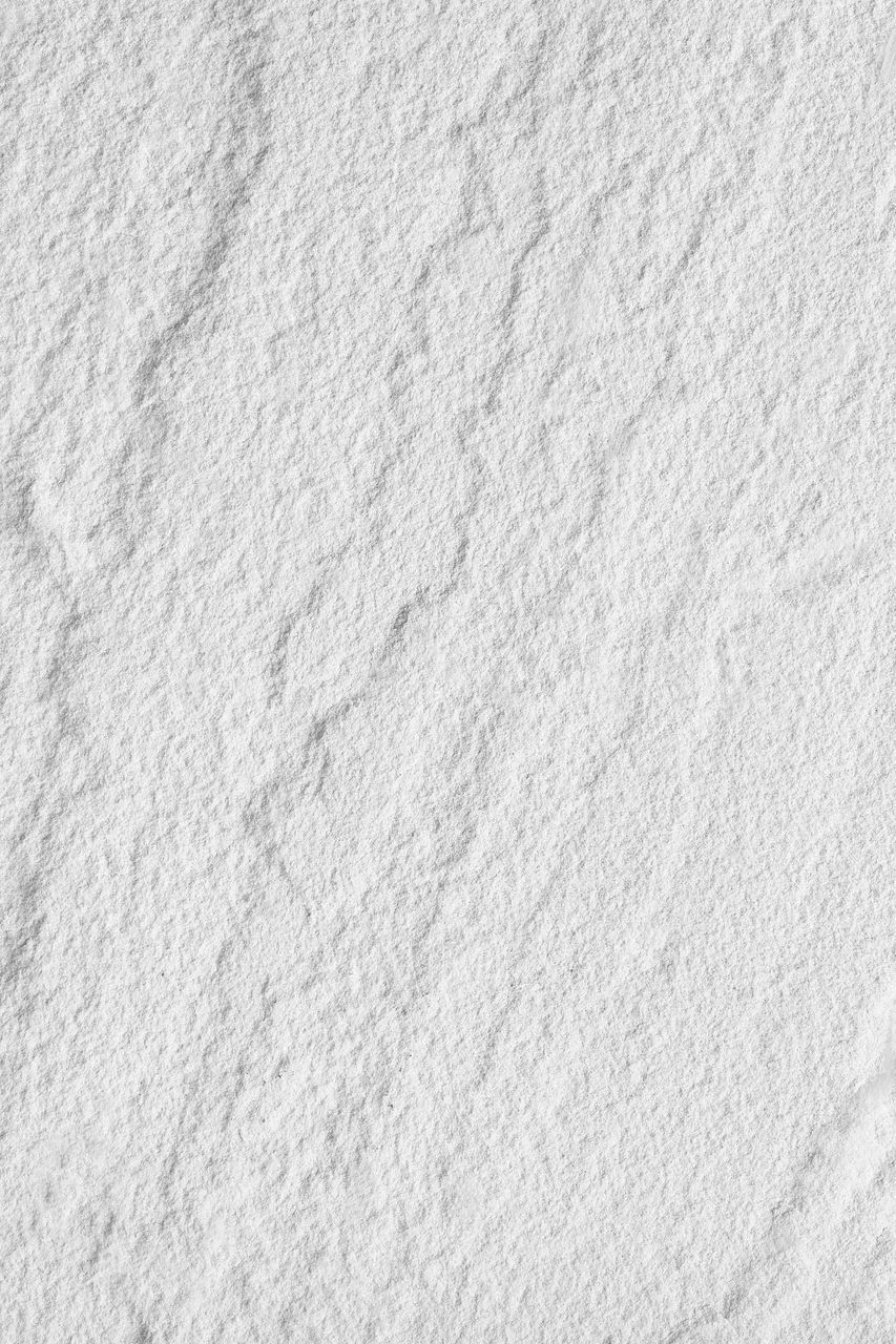 HIGH ANGLE VIEW OF SNOW ON WHITE SURFACE