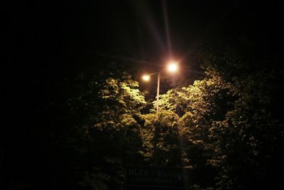 Low angle view of illuminated street light at night