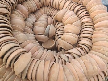 Ceramic diya stacked for sale at market during diwali festival