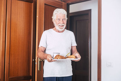 Portrait of smiling young man holding food