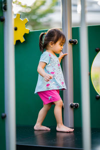 Full length of girl playing on play equipment