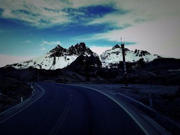 Road by landscape against sky