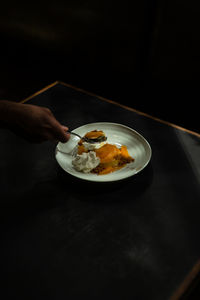 Close-up of person eating food in plate