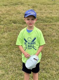 Portrait of boy standing on grassy field