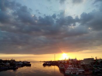 Scenic view of sea against cloudy sky at sunset