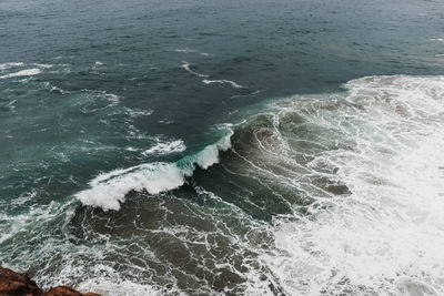 High angle view of waves splashing in sea