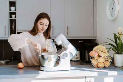 Cute girl preparing food at home