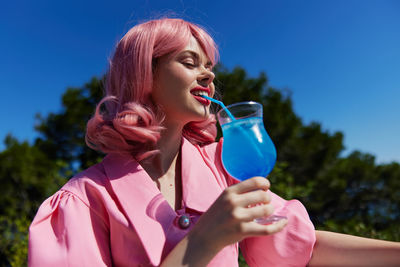 Midsection of woman drinking water