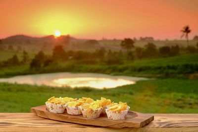 Table on field against sky during sunset