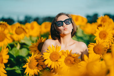 Close-up of woman with yellow flowers