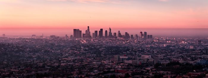 Aerial view of buildings in city during sunset