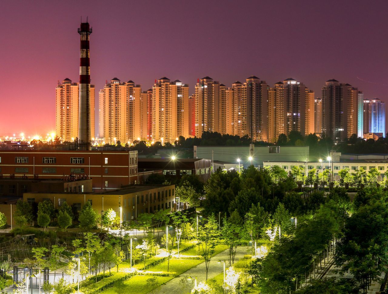 building exterior, architecture, built structure, city, illuminated, skyscraper, night, modern, tree, tall - high, cityscape, office building, tower, urban skyline, clear sky, growth, city life, building, sky, travel destinations