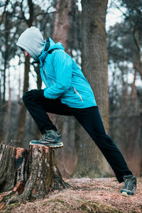 Young man exercising in forest