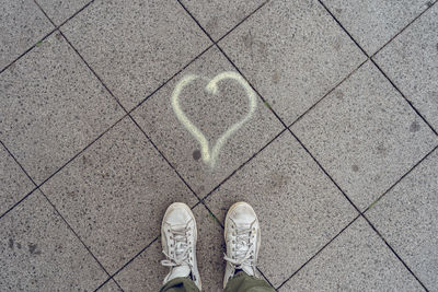 Low section of person standing on tiled floor