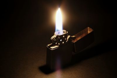 Close-up of lit cigarette lighter