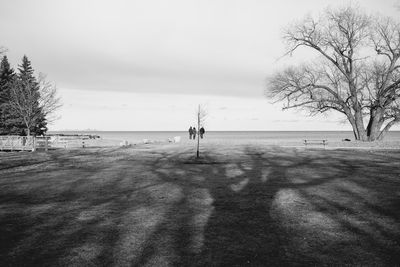 Scenic view of beach in cold weather against sky