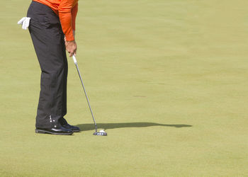 Low section of man playing golf