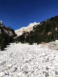 Scenic view of snowcapped mountains against clear blue sky