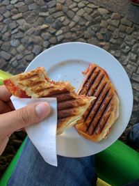 Close-up of man holding toasted bread