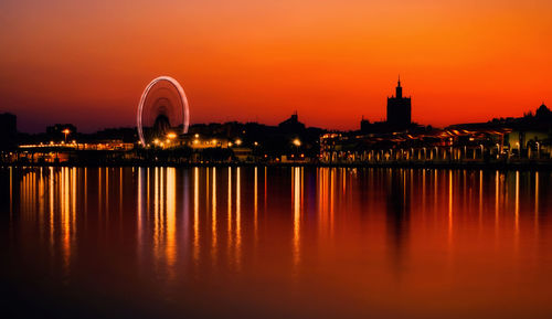 Sunset over ferris wheel and malaga port promenade muelle uno at malaga city, spain, western europe