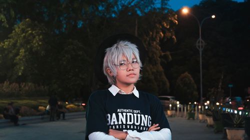 Portrait of boy standing at night