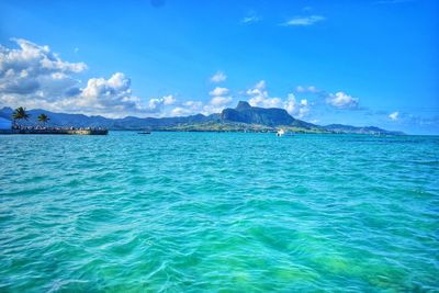 Scenic view of sea against cloudy sky