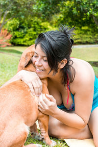Side view of young woman with dog