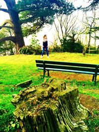 Boy sitting on bench in park