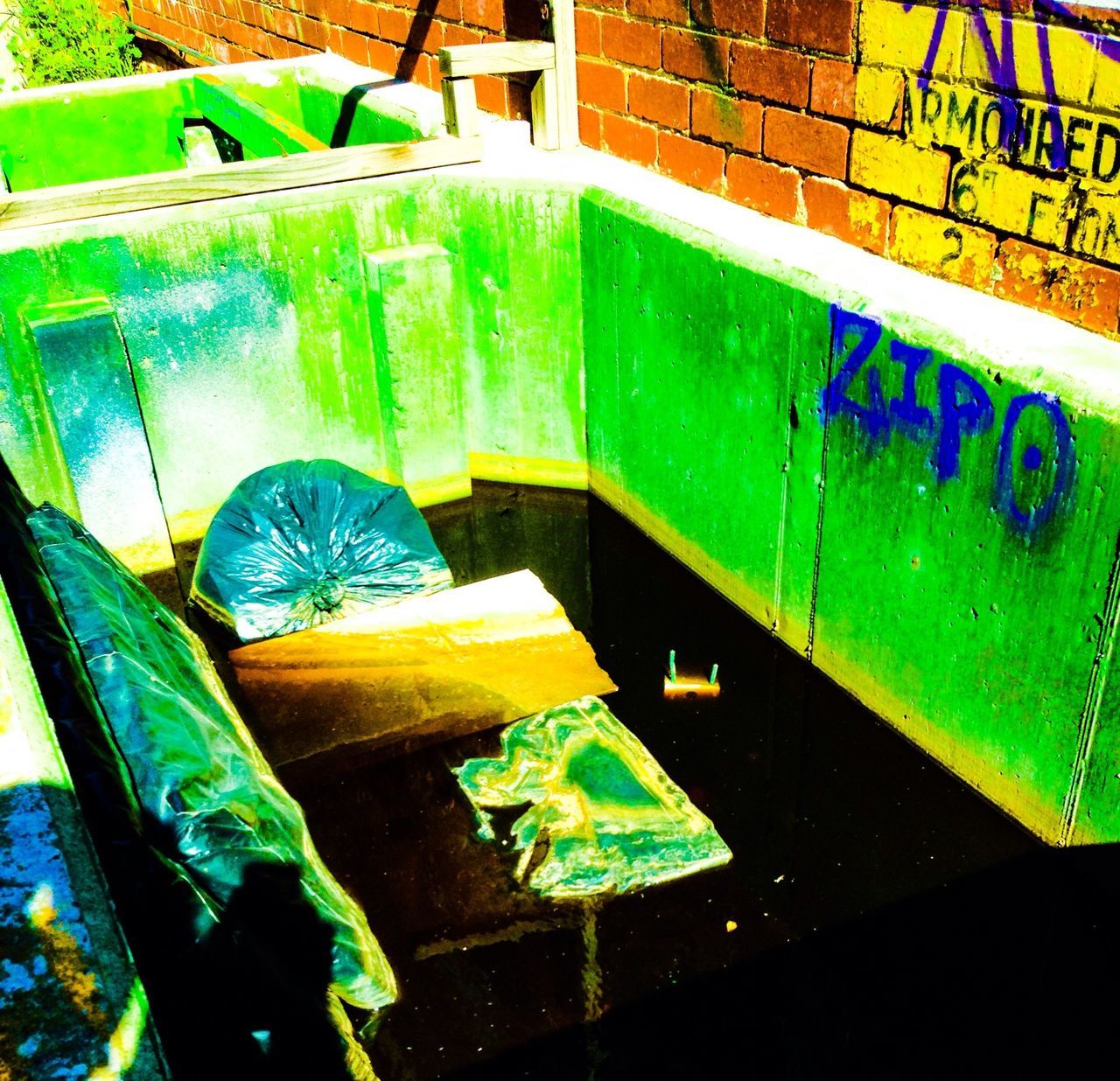 water, high angle view, blue, no people, table, built structure, abandoned, green color, swimming pool, architecture, day, chair, reflection, empty, indoors, absence, sunlight, damaged, close-up