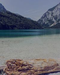 Scenic view of sea and mountains against sky