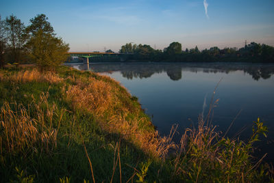 Scenic view of lake against sky during sunset