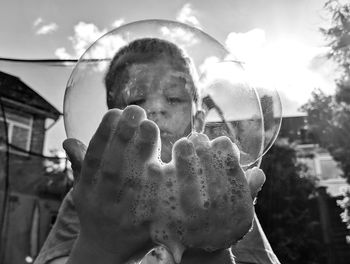 Close-up portrait of boy holding bubbles