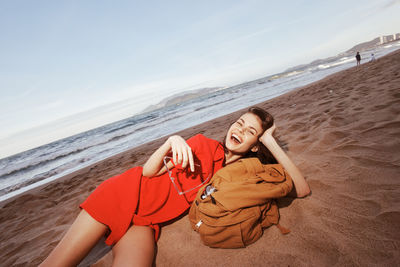 Portrait of woman sitting at beach