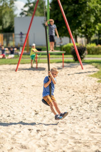 Boy playing on sand at playground