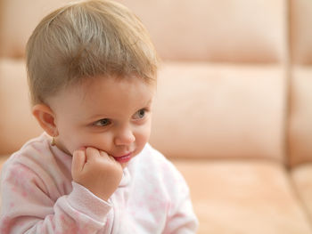 Close-up of cute baby girl at home