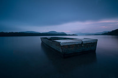 Scenic view of lake against sky at dusk