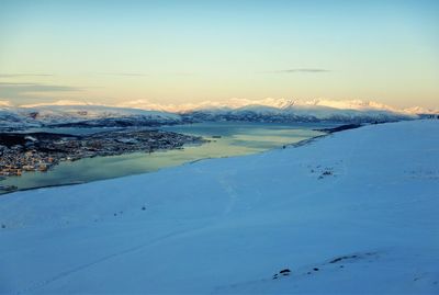 Scenic view of snow covered mountains against sky during sunset