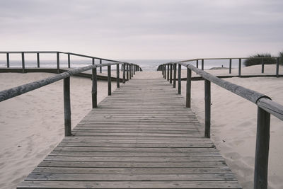 Gangway amidst sand on a beach