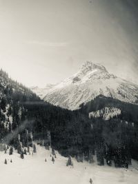 Scenic view of snow covered mountains against sky