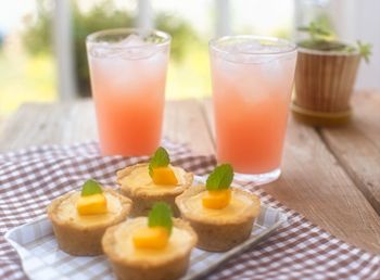 Close-up of drink and tart served on table