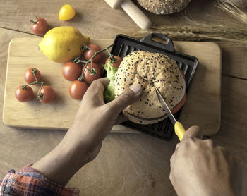 High angle view of person preparing fruits on cutting board