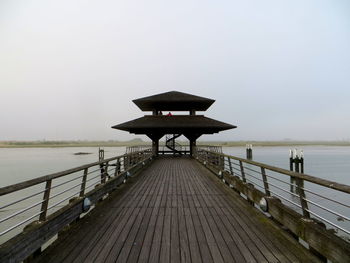 Pier over sea against clear sky