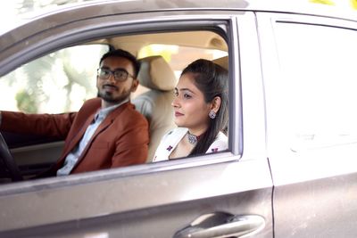 Portrait of friends sitting in car