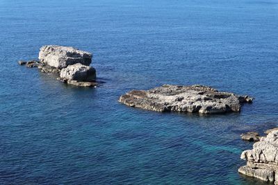 High angle view of rocks in sea